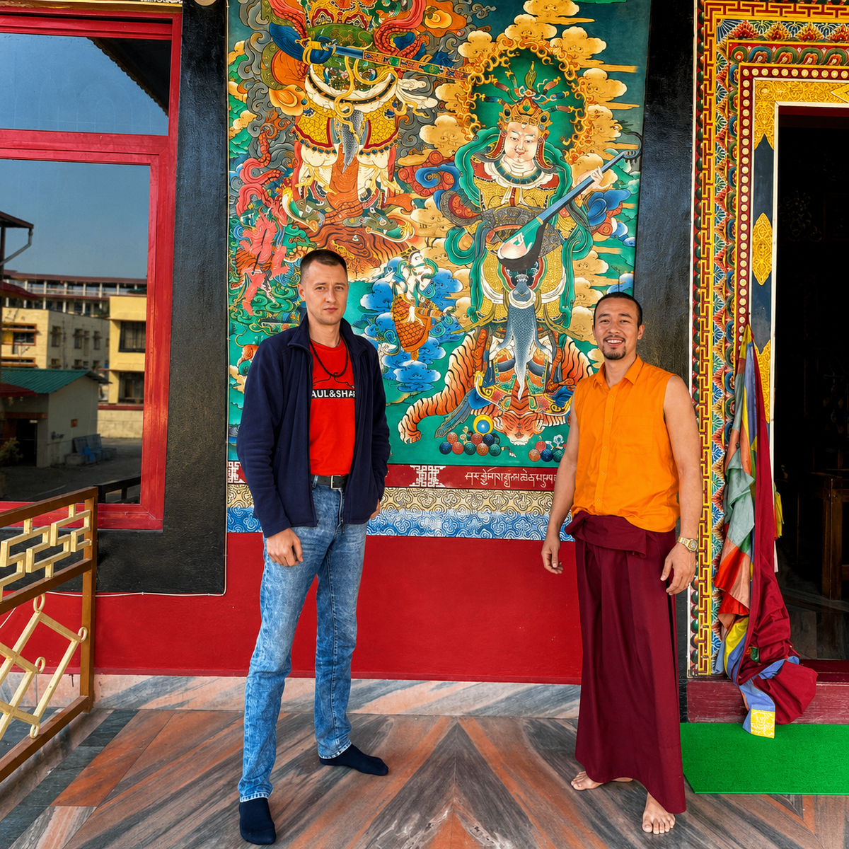 Valentin Roganov with a Tibetan lama in front of a green thangka